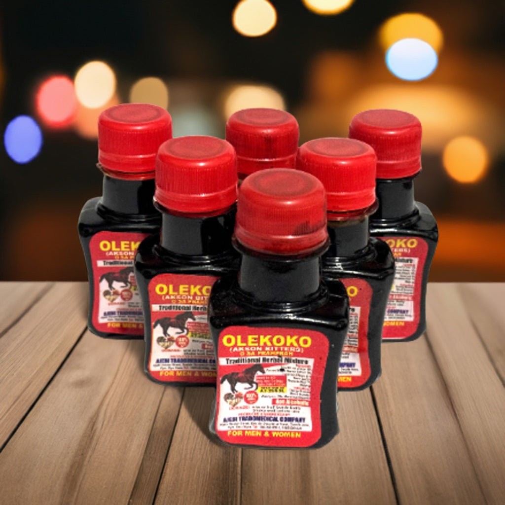 Six bottles of Olekoko Herbal Mixture on a wooden table